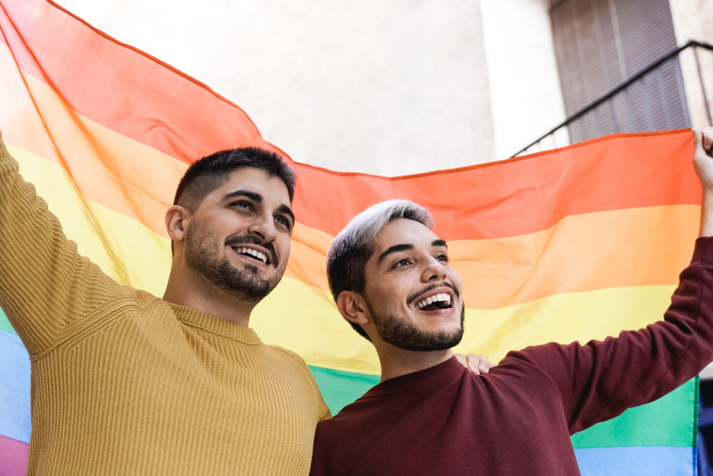 gay-male-couple-holding-lgbt-rainbow-flag-at-gay-p-2021-12-09-07-38-38-utc